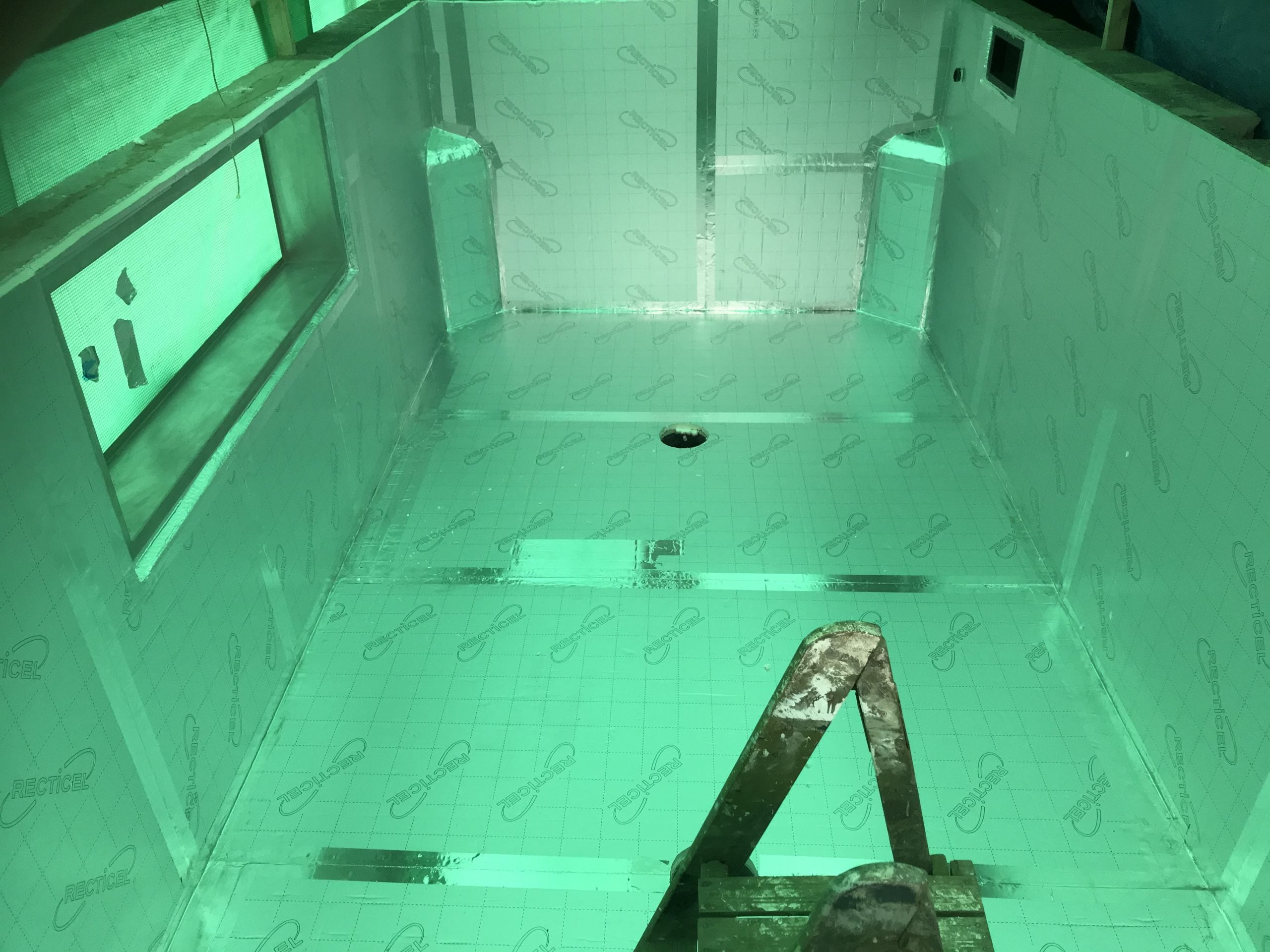 Raised pond with viewing window - waterfall feature